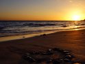 Herz am Strand bei Sonnenuntergang
