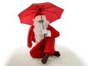 Der Weihnachtmann sitzt unter einem Regenschirm.